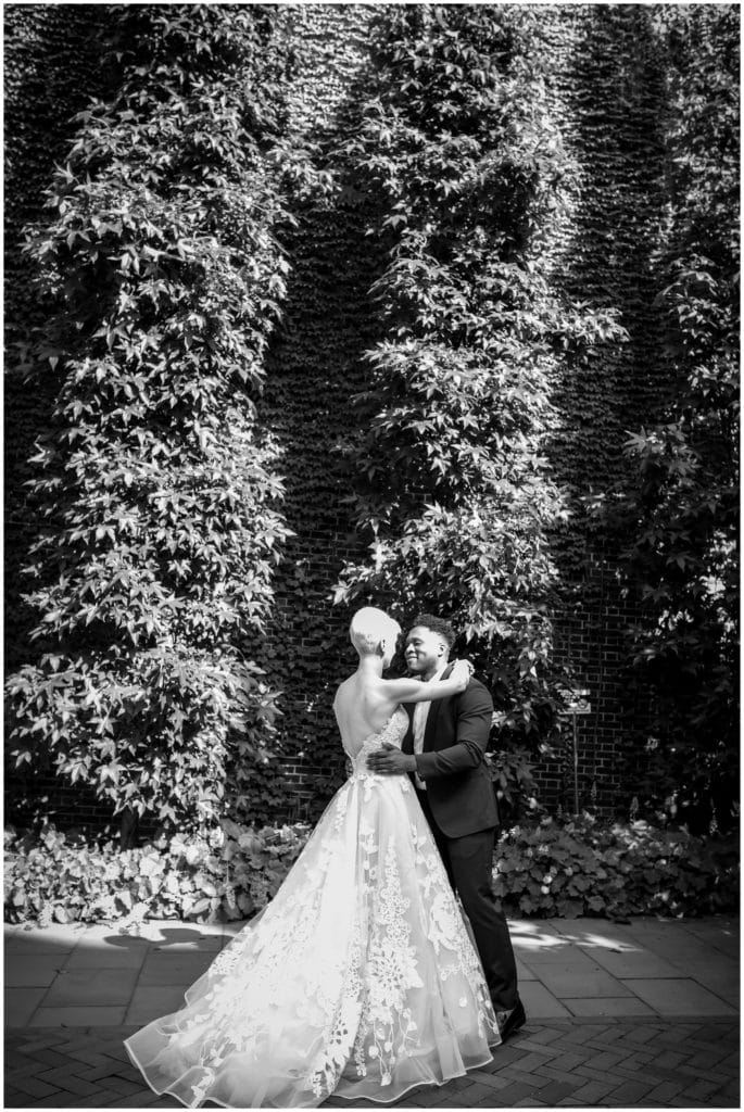 Black and white bride and groom gazing into each others eyes at first look
