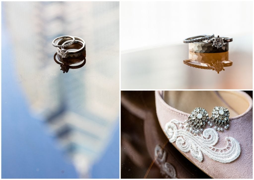 Engagement ring and wedding bands with skyscraper reflection and earrings on shoe details