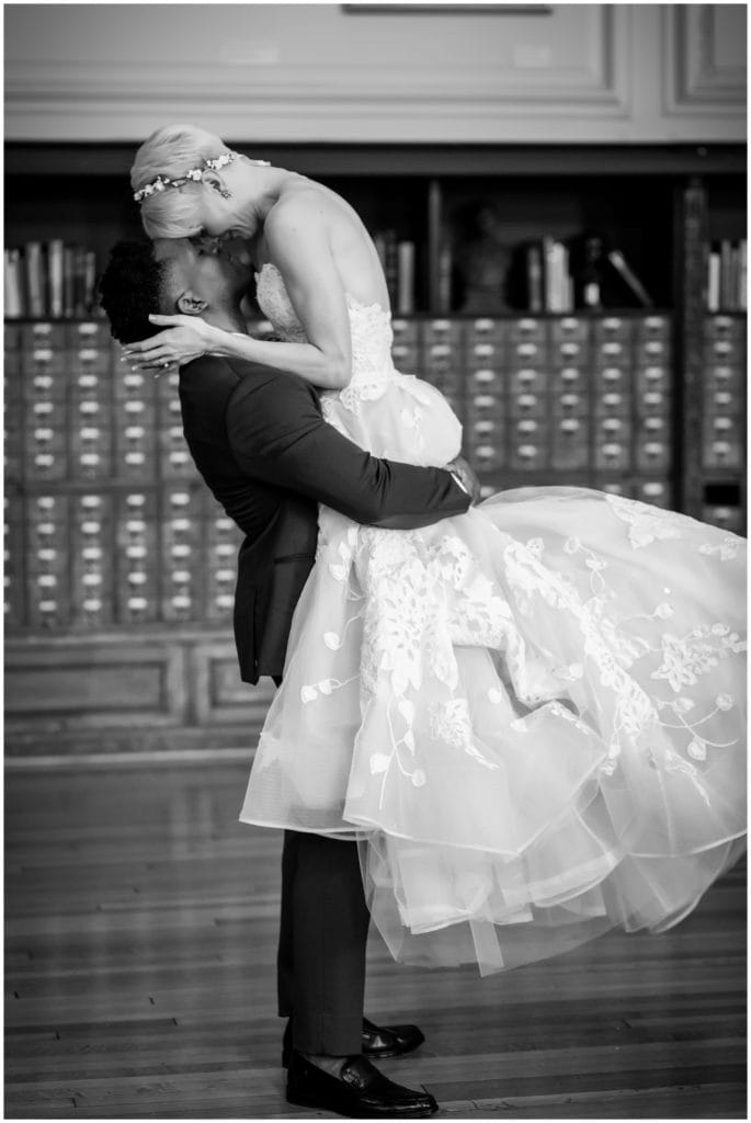 Black and white bride and groom portrait with groom lifting bride and looking into her eyes