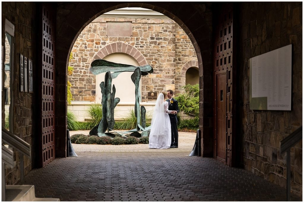 Bride and groom embracing through tunnel at the Michener Musuem