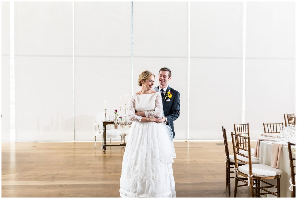 Bride and groom holding each other in their reception space before it is revealed at the Michener Museum