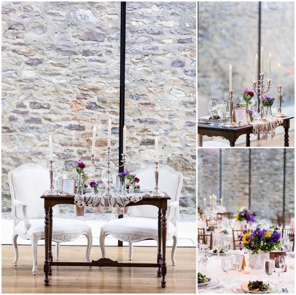 Bride and groom table with lace, purple florals, and candelabras at Michener Museum wedding reception