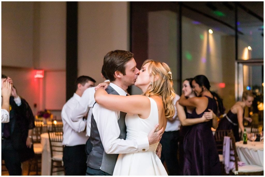 Bride and groom kiss on the dance floor of Michener Museum wedding reception