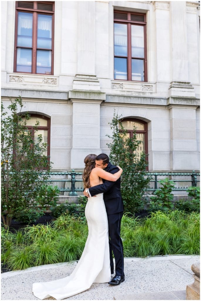 Bride and groom embracing after first look at Philadelphia City Hall