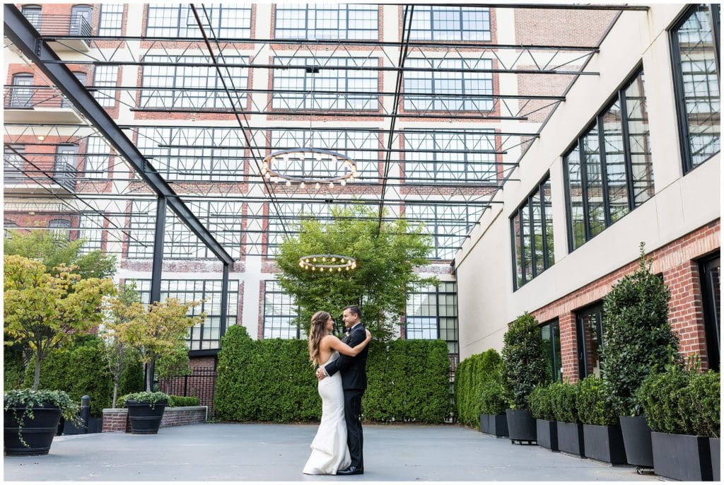 Bride and groom hugging outside Vie courtyard space