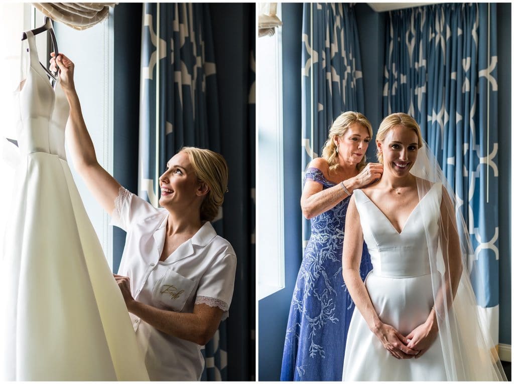 Bride admiring and putting on her wedding dress with her mothers help