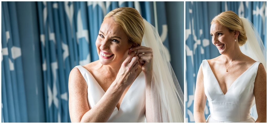 Window lit bridal portraits, bride putting on her earrings