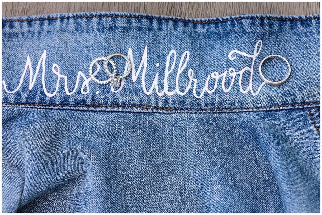 Custom jean jacket with brides name painted and wedding bands
