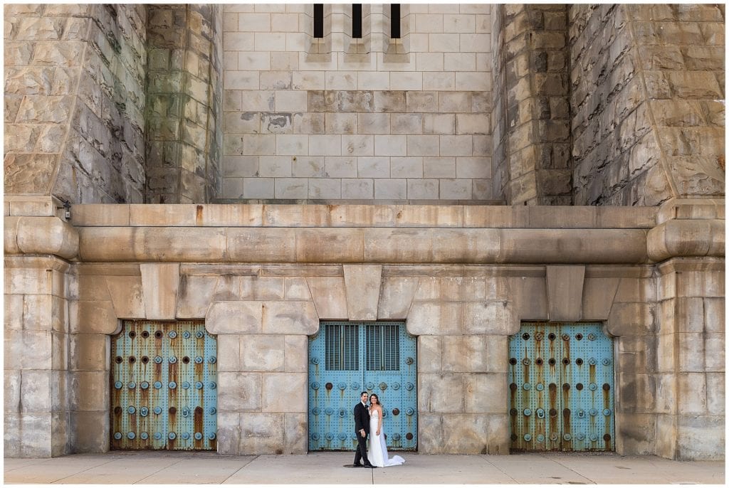 Bride and groom traditional portrait in front of bridge gates in Philadelphia