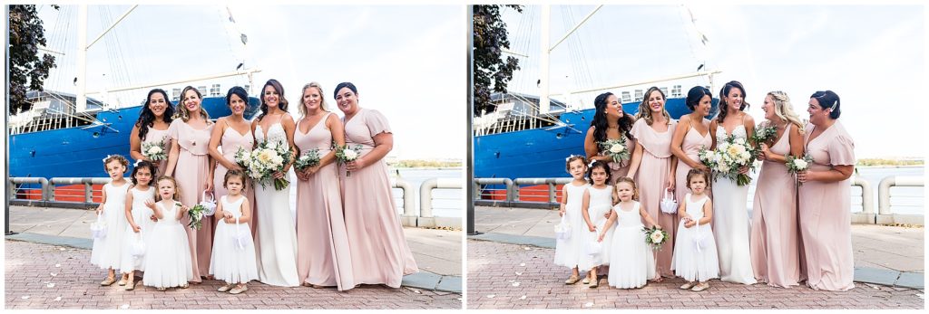 Bridesmaids and flower girls laughing on pier in front of boat wedding venue in Philadelphia
