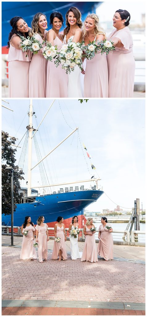 Bridesmaids laughing and holding up their bouquets on pier in front of boat wedding venue in Philadelphia