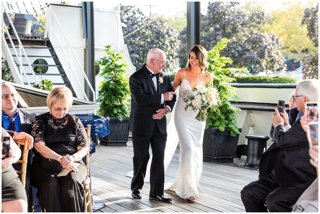 Father of the bride walking bride down the aisle of Moshulu Philadelphia wedding ceremony