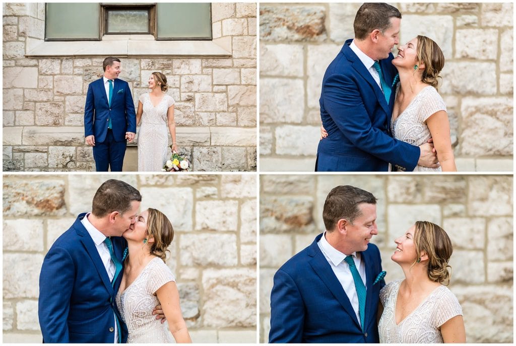 Traditional bride and groom portraits with bride and groom laughing, smiling, and kissing against stonewall in Philadelphia