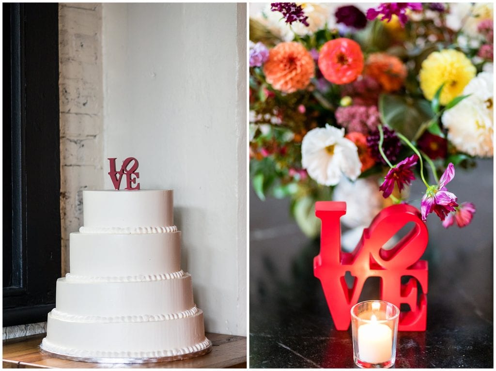Philadelphia themed wedding with LOVE cake topper and table signs with colorful floral centerpieces at Osteria Wedding