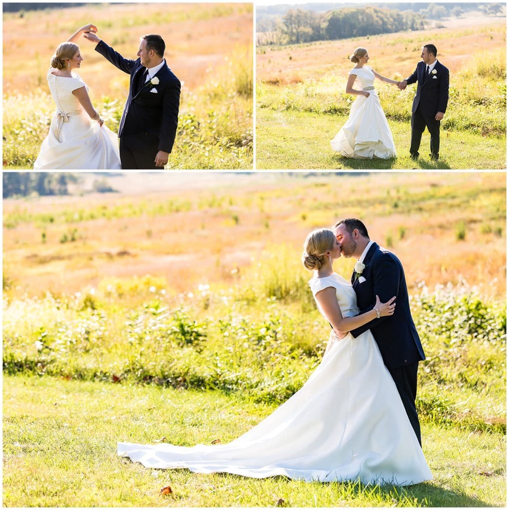 Groom spinning and kissing bride in a field at Valley Forge National Park