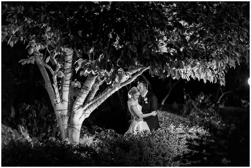 Black and white wedding portrait night shot in garden at Radnor Hotel wedding reception