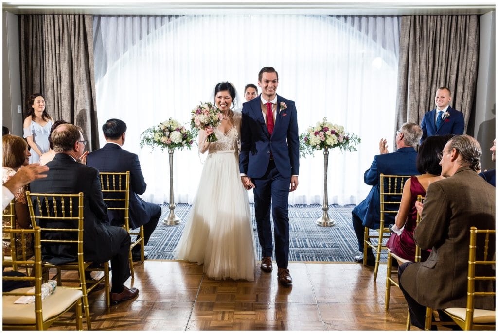 Bride and groom walking up the aisle after wedding ceremony