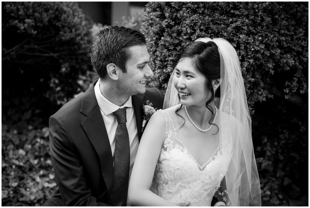 Traditional black and white bride and groom gazing at each other portrait