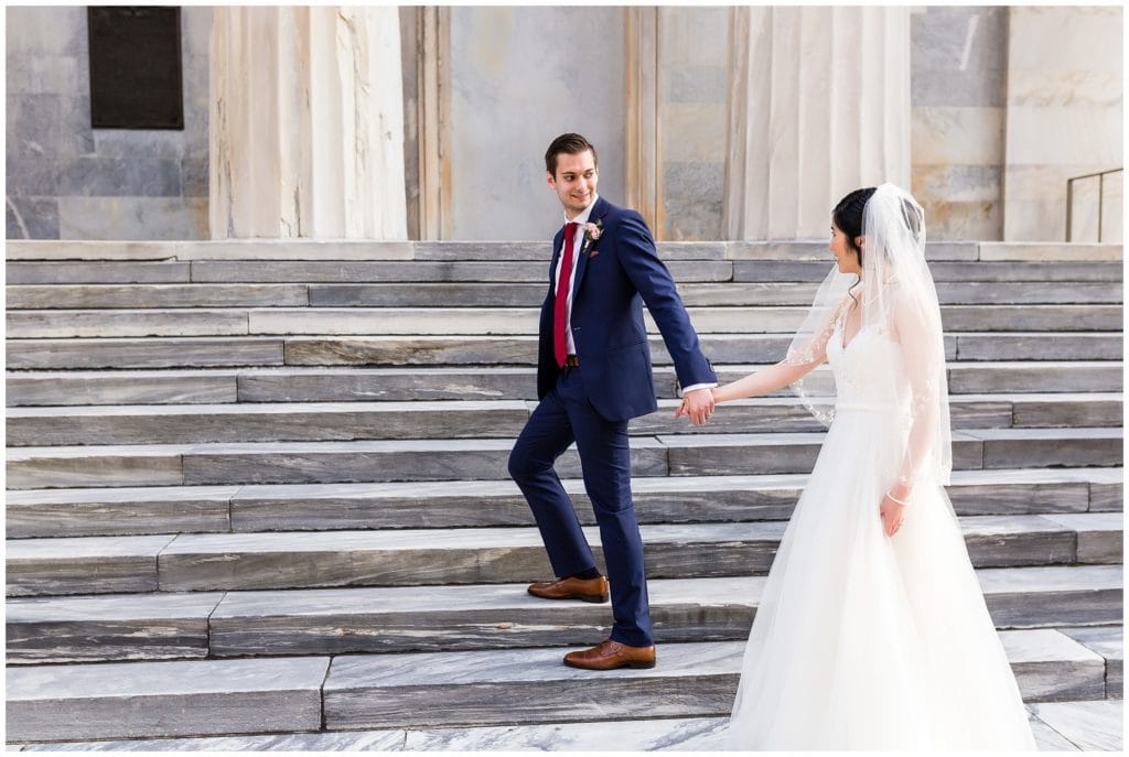 Bride and groom walking up stairs together