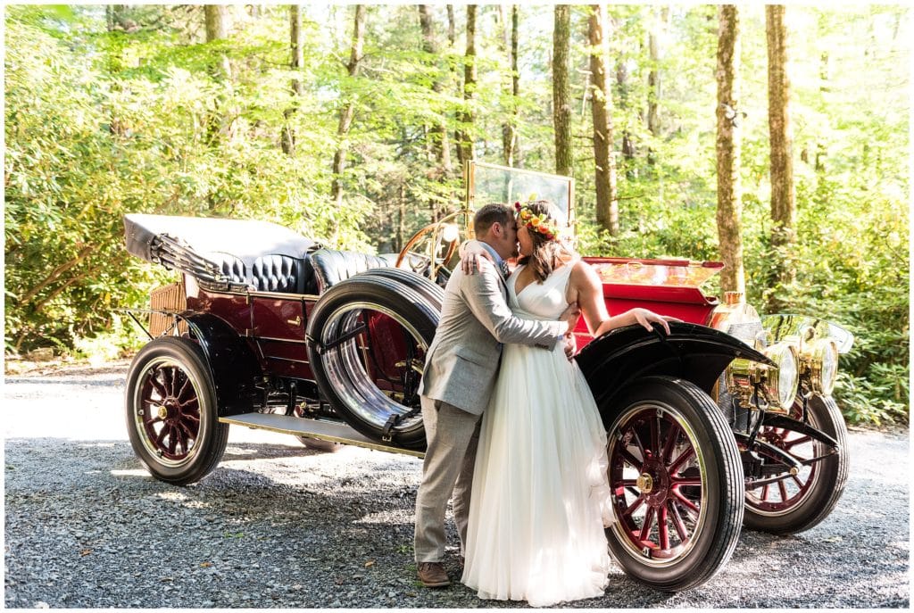 Bride and groom romantic portrait with classic car