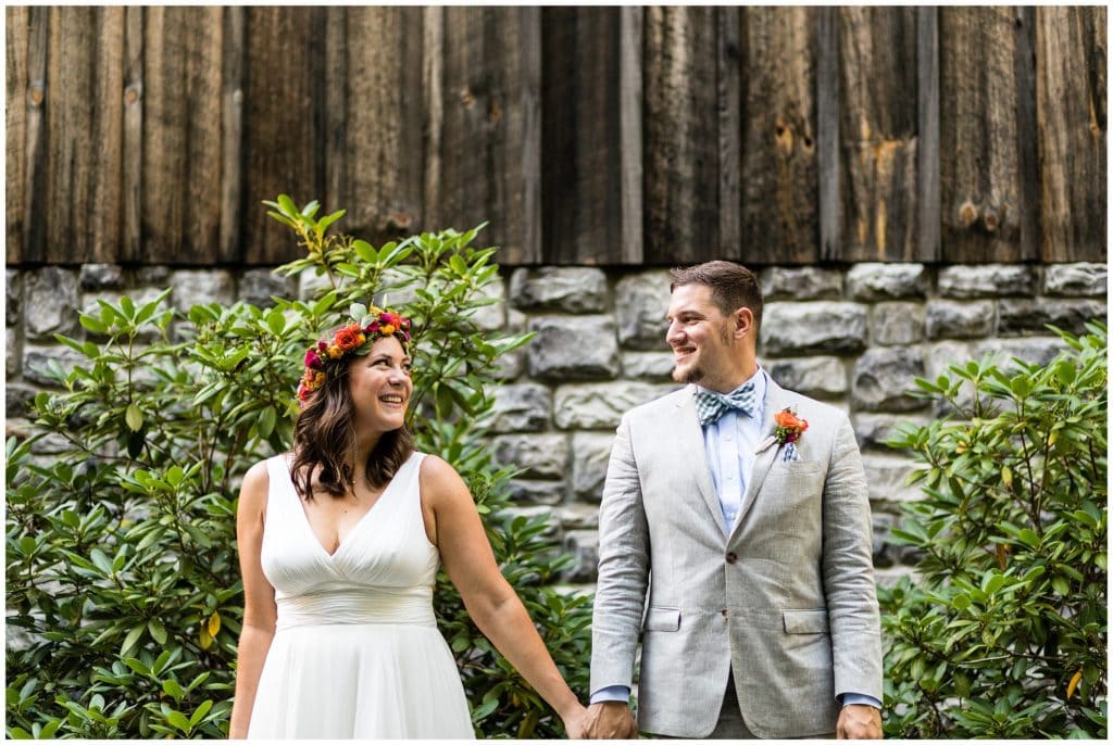 Bride and groom looking and smiling at each other portrait