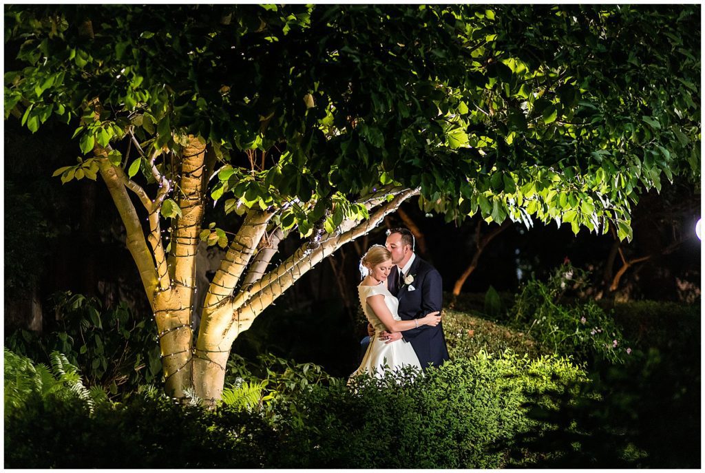 dramatic nighttime portrait of bride and groom in the courtyard at the Radnor Hotel
