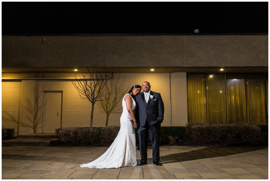 outdoor night time portrait of newlyweds in the courtyard of the Windsor Ballroom