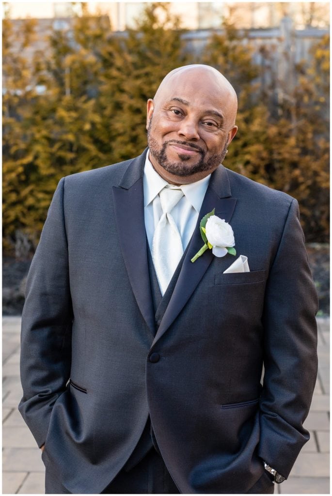 outdoor groom portrait in the courtyard of the Windsor Ballroom