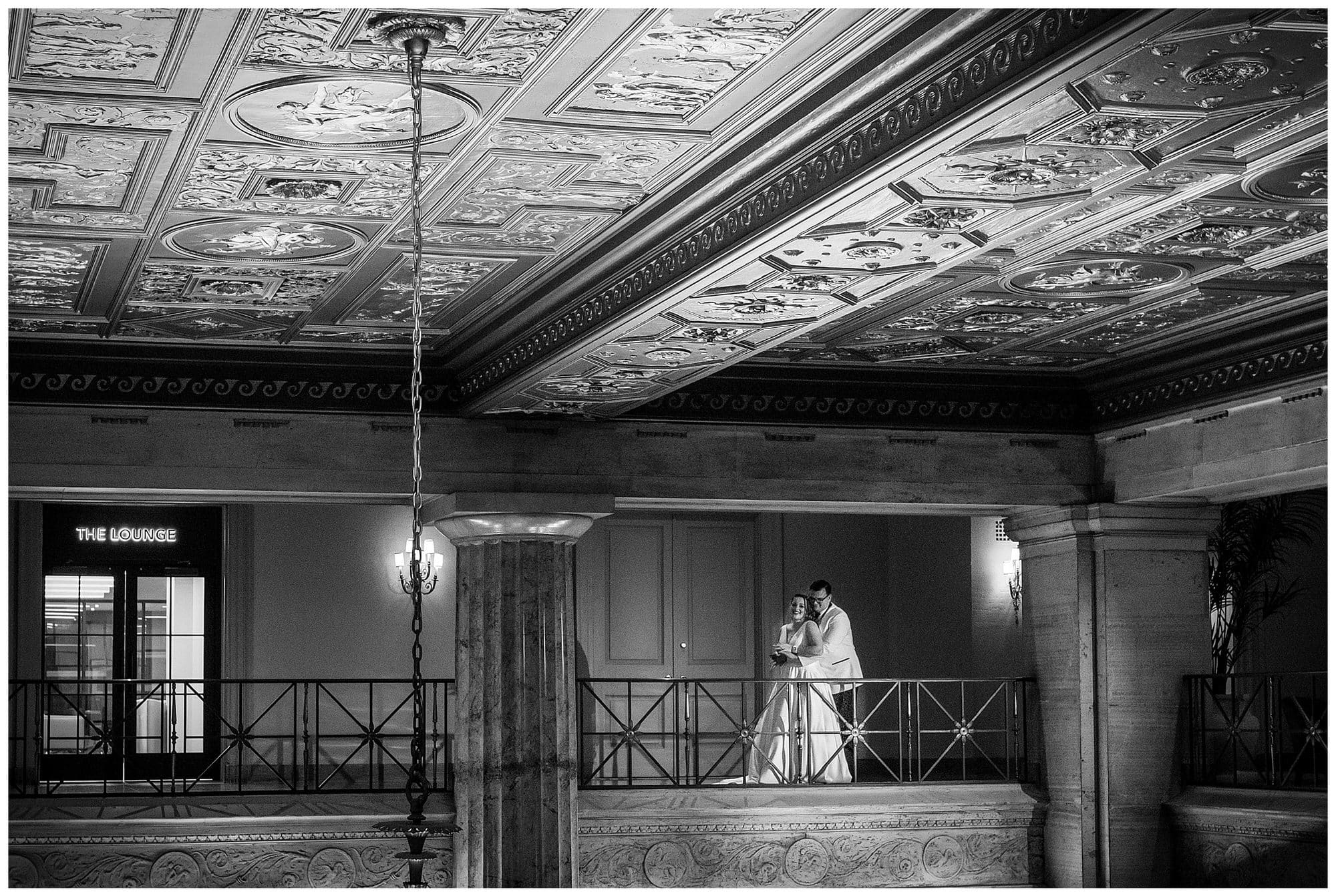 Dramatic portrait of bride and groom on the mezzanine of the Ballroom at the Ben