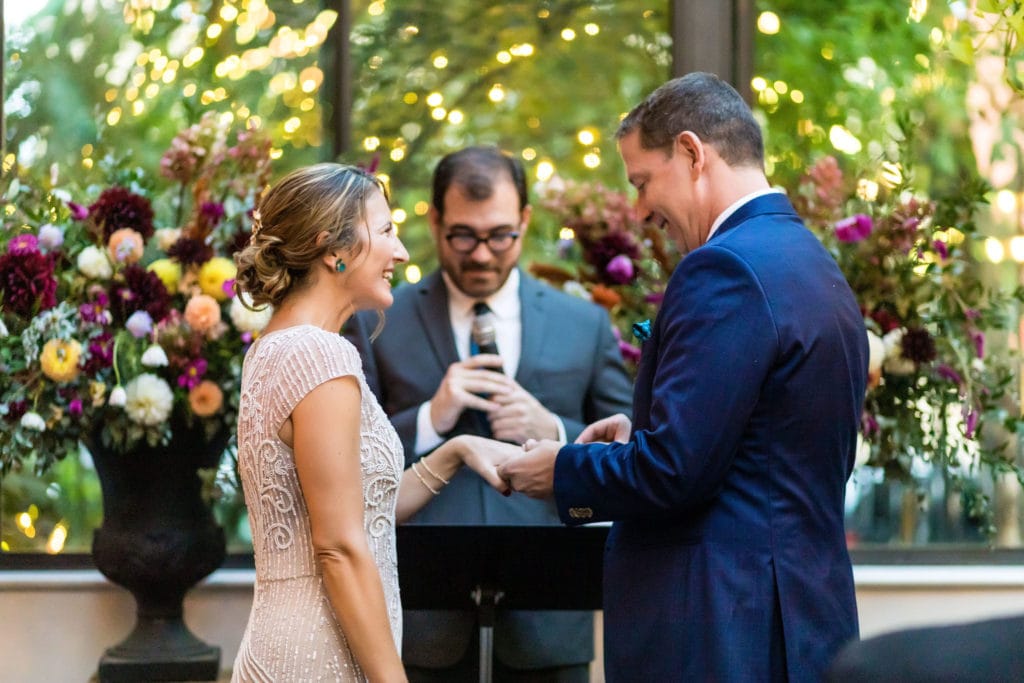 Ring exchange during self-uniting marriage license ceremony officiated by a friend of the couple