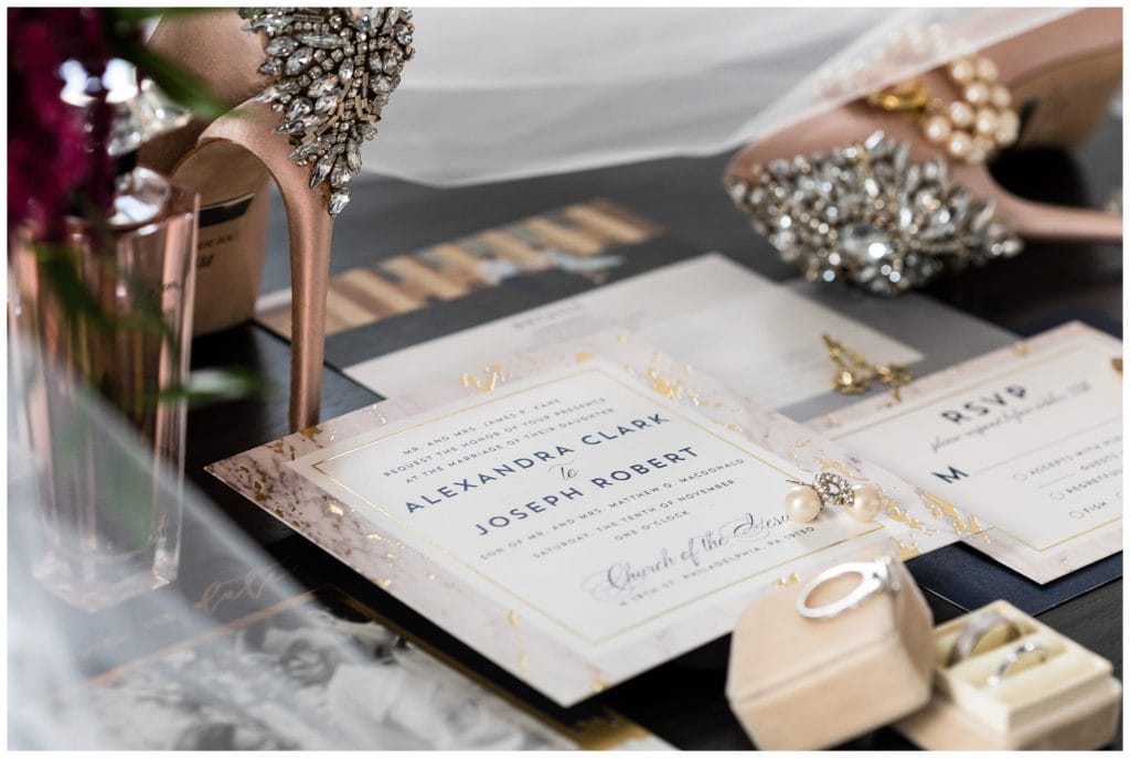 White and gold wedding invitation suite with bridal accessory details