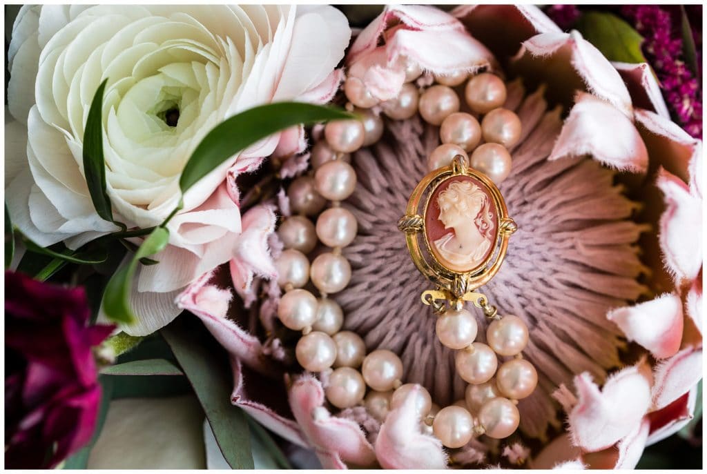 Rosary detail in pink bridal bouquet flower