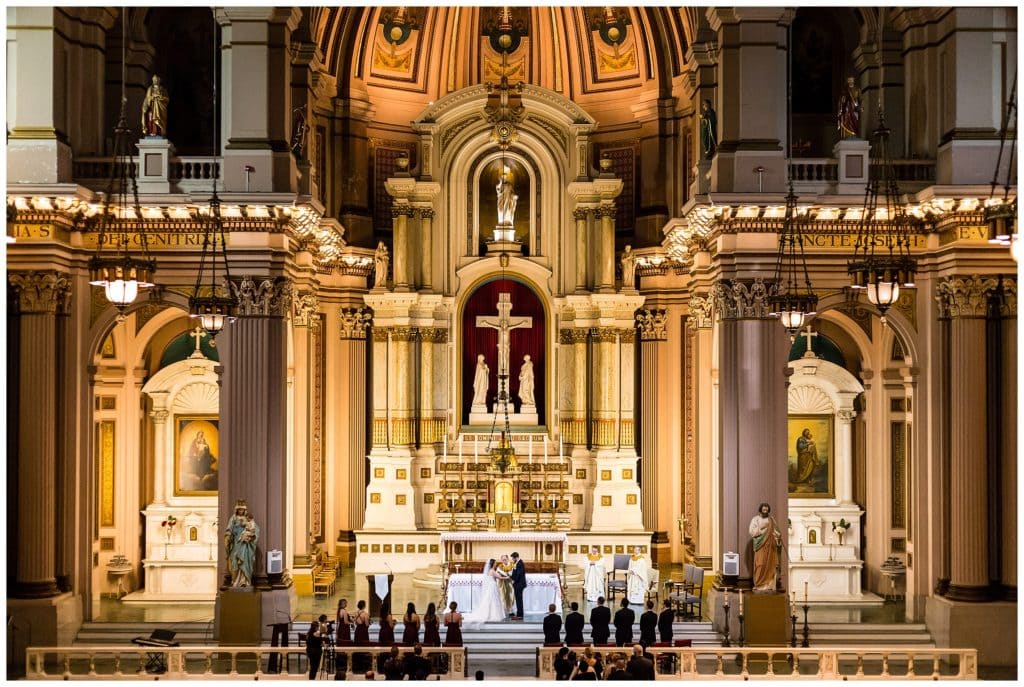 Alter shot of St. Joe's Prep wedding ceremony with bride and groom exchanging vows