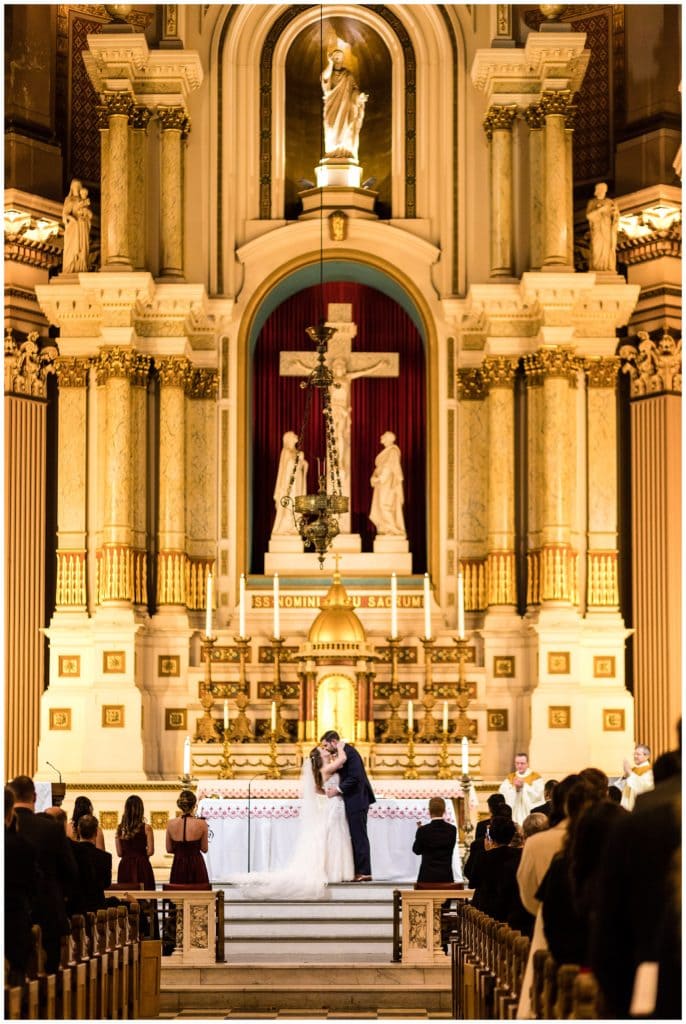 Bride and groom first kiss at the alter in Church of the Gesu wedding ceremony, St. Joe's Prep wedding ceremony