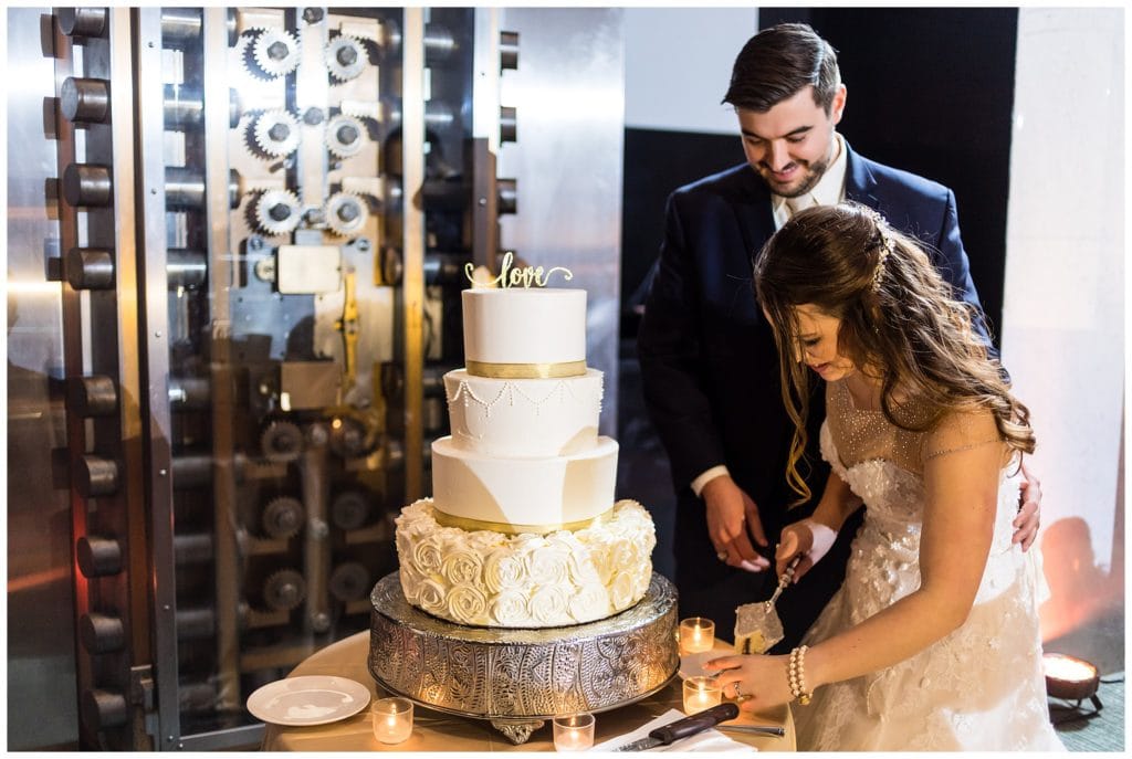 Bride and groom cut traditional wedding cake at Loews Philadelphia wedding reception