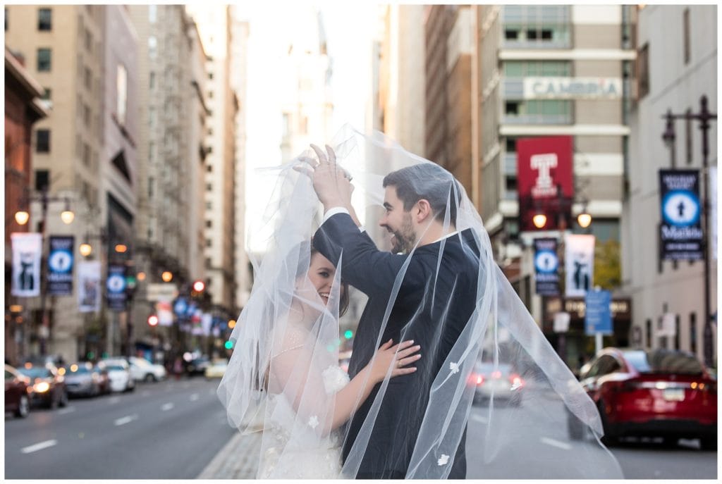 Bride and groom tangled under veil in Philadelphia wedding