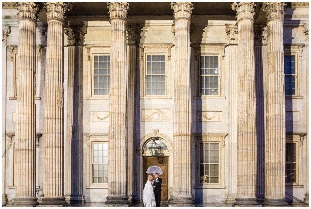 Bride and groom with umbrella portrait at First National Bank in Philadelphia