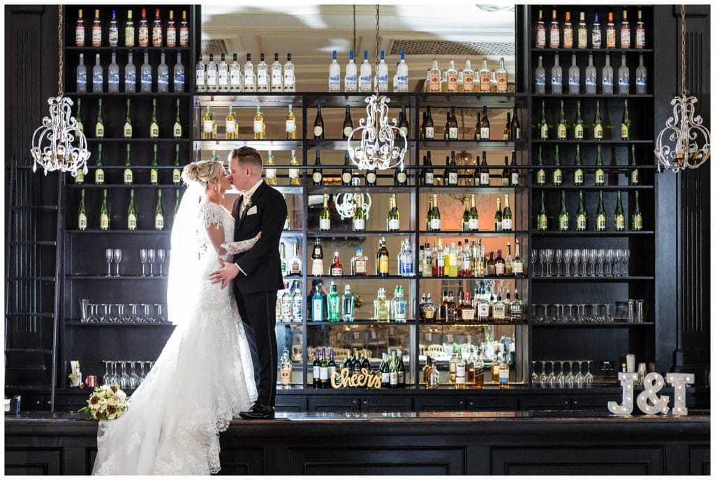 Bride and groom backlit portrait on bar at New Year's Eve Cescaphe Ballroom wedding