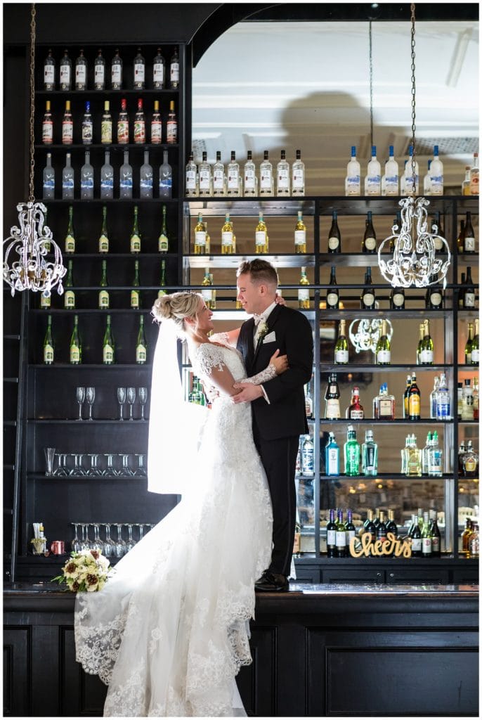 Bride and groom backlit portrait on bar at New Year's Eve Cescaphe Ballroom wedding