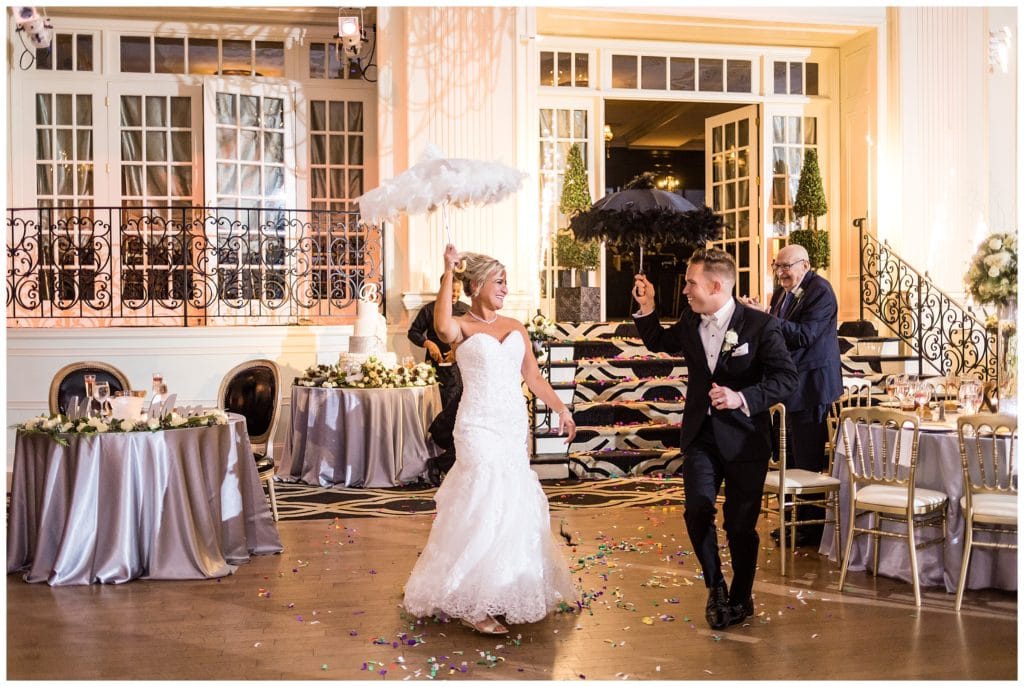 Bride and groom entrance with fancy parasols at Cescaphe Ballroom New Year's Eve wedding