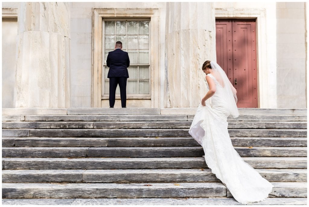 Bride and groom first look on steps at Second National Bank in Philadelphia