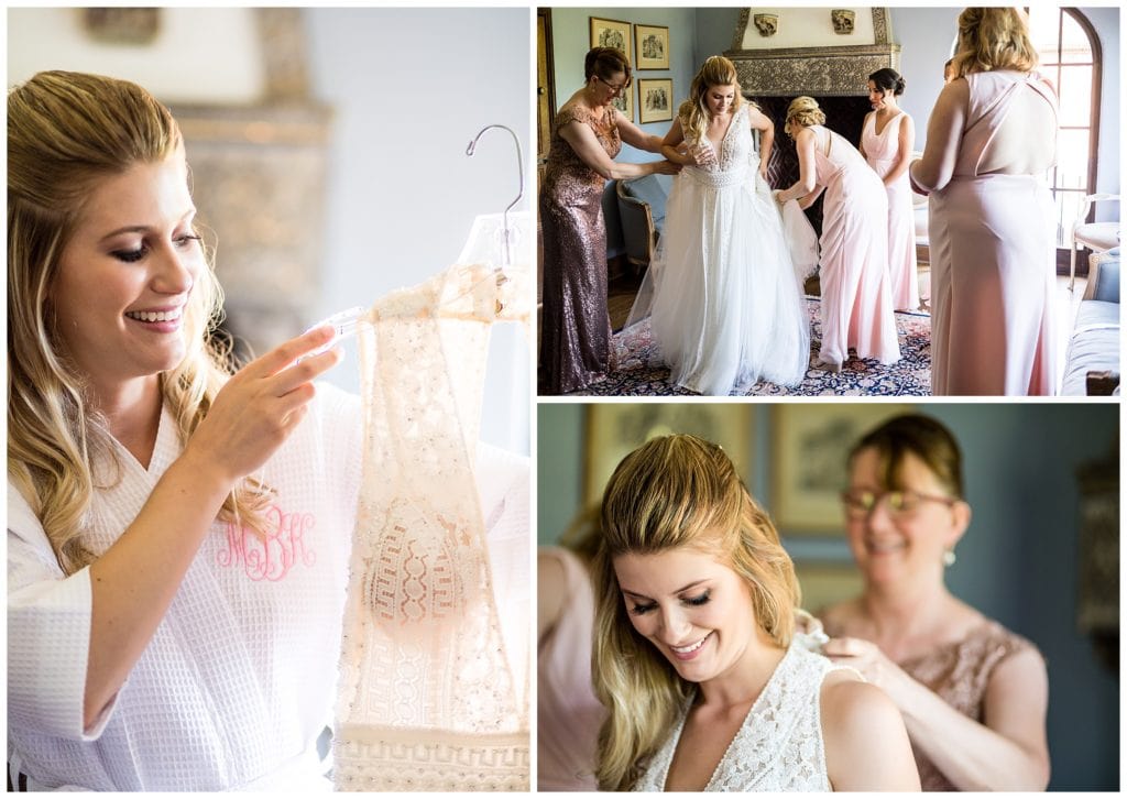 Bride admiring and getting into wedding gown with help from mother and bridal party at Aldie Mansion wedding