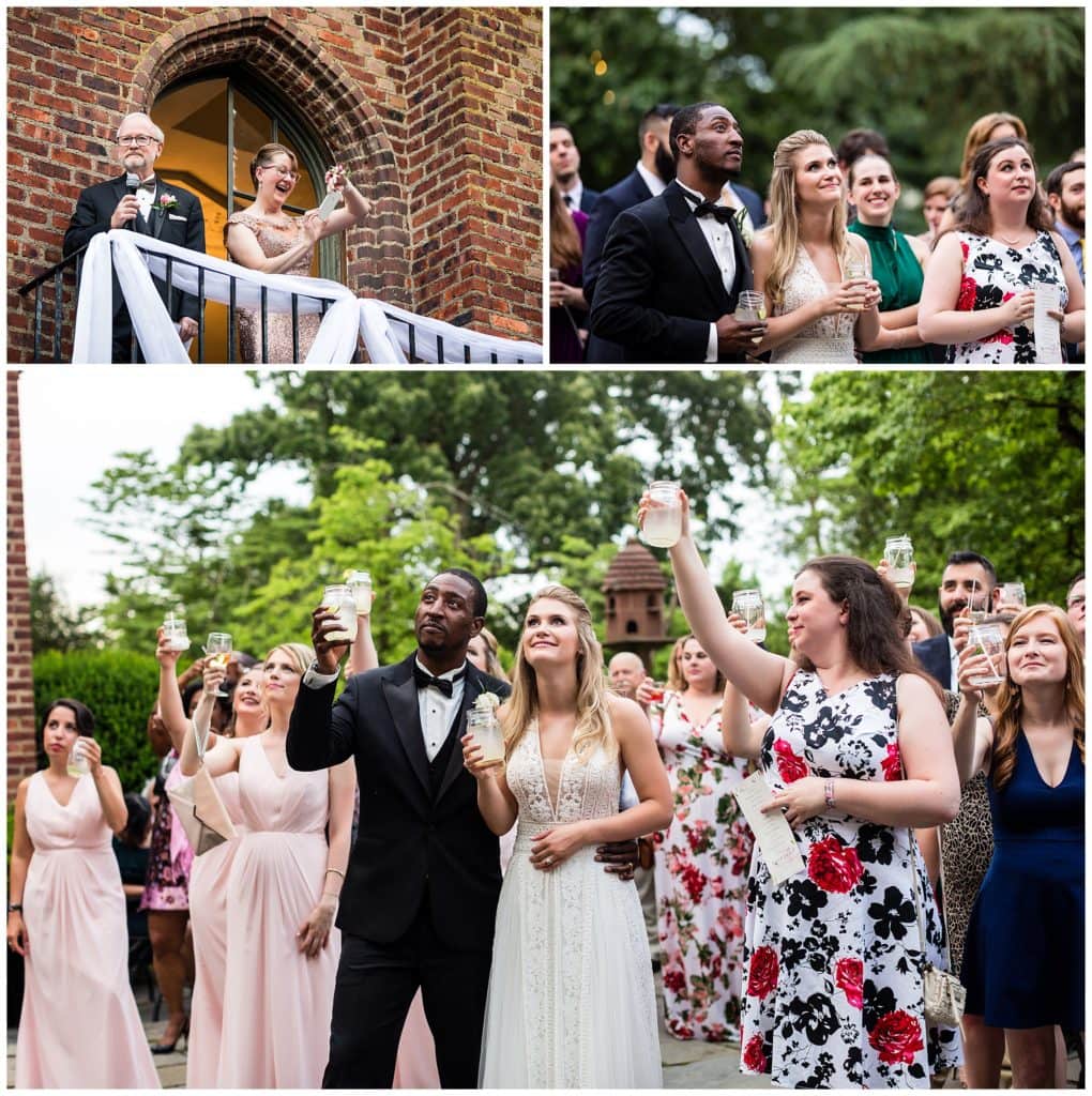 Bride and groom listen and toast during parent speeches from balcony above at Aldie Mansion wedding reception