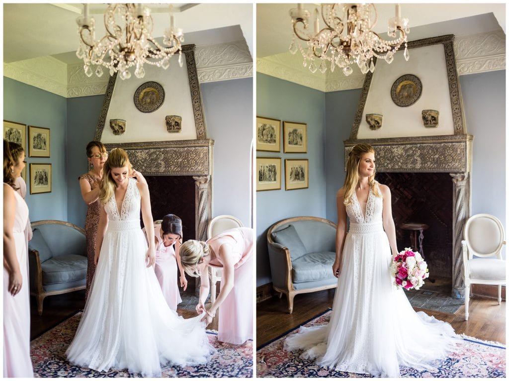 Mother of the bride and bridesmaids fixing dress on bride with traditional window lit bridal portrait at Aldie Mansion wedding