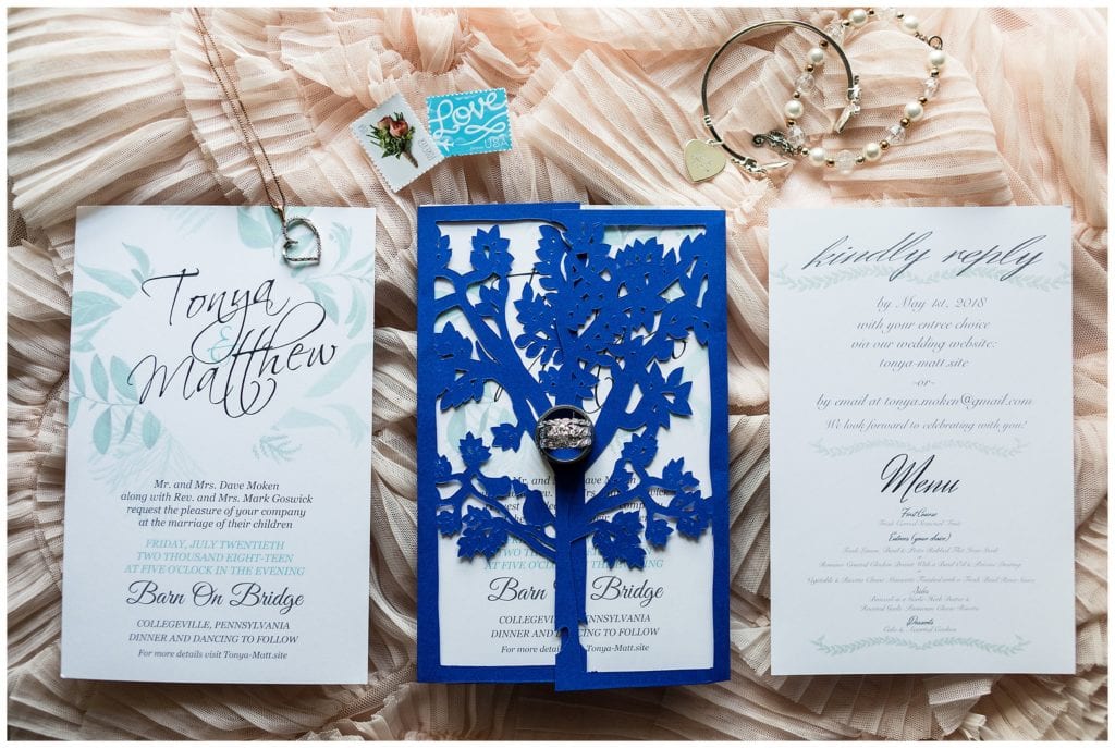 Blue leaf wedding invitation suite with stamps and bridal jewelry