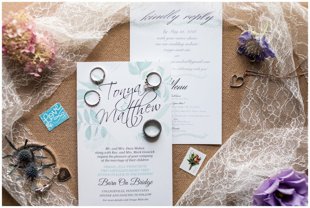Wedding invitation suite with bridal jewelry, lace, and floral details