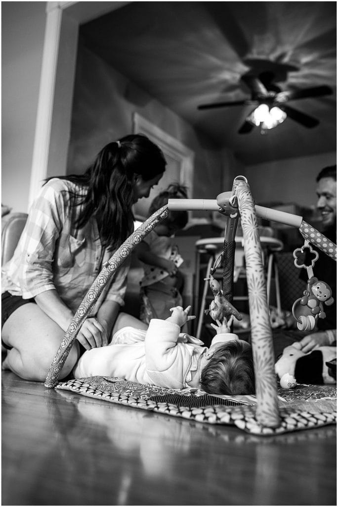 mom with baby on playmat during day in the life family session