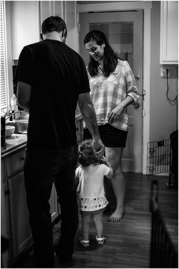 mom and dad helping their daughter in the kitchen during their day in the life family session