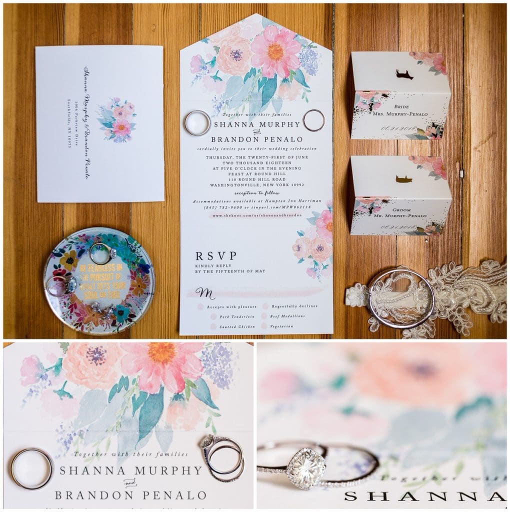 Floral watercolor wedding invitation suite with wedding bands and engagement ring next to bride and groom names