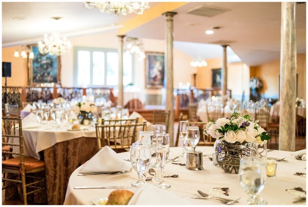 FEAST at Roundhill wedding reception table with white rose and twig centerpieces